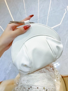 Détail du sac nuage blanc plissé avec poignée anneau doré élégante pour les soirées