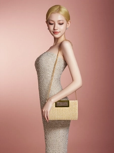 Detail of light beige woven clutch with rectangular gold metal handle and chain strap