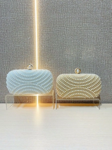 Elegant pearl evening clutch bags in white and champagne with decorative top handle