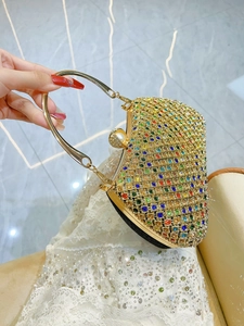 Luxury gold evening clutch bag with colorful rhinestones and elegant pearl clasp