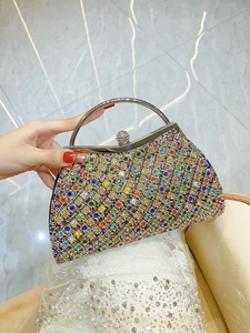 Macro shot of colorful rhinestone pattern and silver metal handle on a luxury evening bag