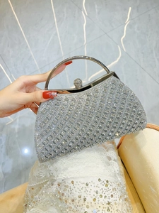 Macro view of silver evening bag with sparkling rhinestones and metal handle