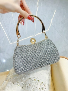 Detail of silver rhinestone evening bag with gold metal handle and pearl clasp