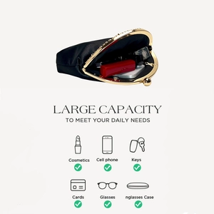 Detail showing the large capacity of the black satin evening clutch for essentials