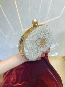 Elegant pearl evening clutch bag with crystal flower detail and golden metal frame