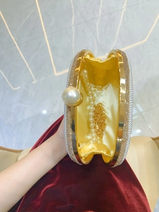 Luxury camellia evening clutch bag with pearl handle and gold metal frame detailing