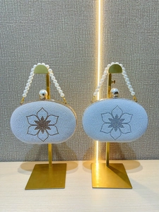 Elegant pearl evening clutch with camellia floral design and beaded handle for formal events