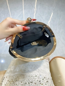 Elegant black suede evening clutch bag with gold frame and chain strap for women