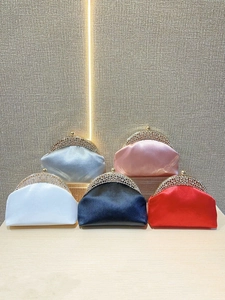 Detail of five colored satin evening clutches with rhinestone-encrusted gold metal frames