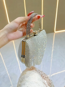 Elegant silver evening clutch bag featuring shimmering rhinestones and fringe tassels