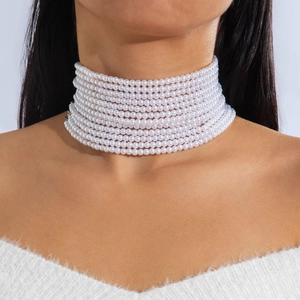 Close-up of elegant multi-layer pearl choker necklace on model's neck for fashion styling