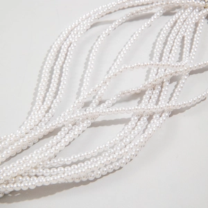 Close-up of multi-layer white faux pearl strand necklace showing lustrous round beads