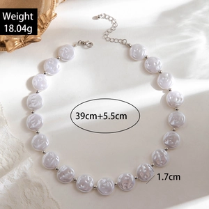 Detail of layered irregular pearl necklace with silver spacers and lobster clasp