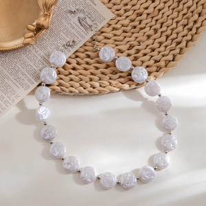 Detailed macro shot of vintage pearl beads with silver spacers and lobster clasp on jewelry