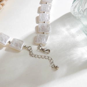 Detail showing the silver lobster clasp and adjustable extension chain of the beaded necklace