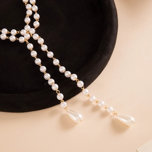 Detailed view of layered faux pearl necklace with elegant teardrop-shaped pendants