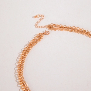 Detail of gold multi-layer chain necklace showing lobster clasp and adjustable extension