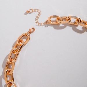 Close-up of golden multi-layer chunky aluminum chain with lobster clasp and extender