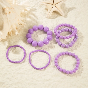 6-piece purple resin beaded bracelet set with starfish and seashell on sand