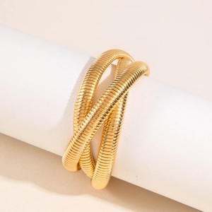 Three-layer gold snake bone texture stacked elastic bracelet with a polished metal finish