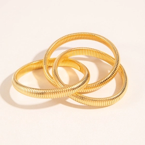 Three-layer gold snake bone texture bangle set with elegant spiral metal design