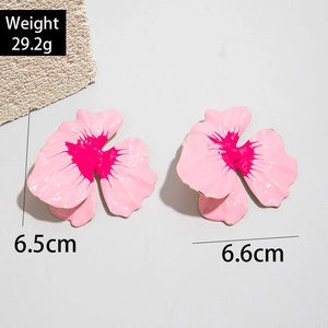 Detail shot of large pink enamel petal earrings showing size dimensions and weight