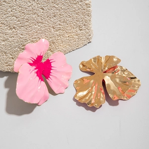 Macro detail of large floral petal stud earrings in contrasting pink and gold finishes