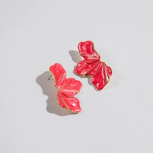 Detailed macro view of red enamel flower petal earrings with refined golden metal edges