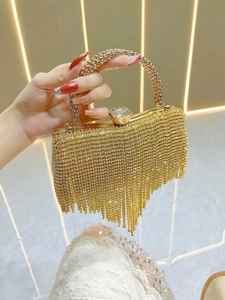 Detail of shimmering gold rhinestone fringe and large crystal clasp on luxury evening bag