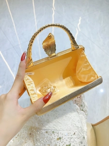 Luxury gold snakeskin textured evening clutch bag with leaf clasp and metal top handle