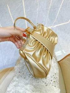 Elegant gold pleated evening clutch bag with rhinestone floral detail and metal handle