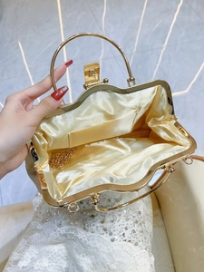Luxury gold evening clutch with rhinestone accents and interior satin lining with chain strap