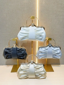 Elegant satin evening clutch bags with oversized gold circular handles and crystal floral clasps