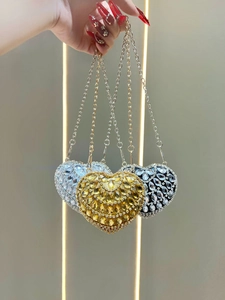 Luxurious heart-shaped evening bag with sparkling rhinestones in gold, silver, and black