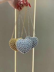 Three mini heart-shaped evening bags with metallic beads in gold, silver and gun black