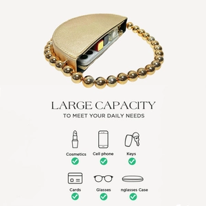 Detail showing high capacity of golden evening clutch bag with beaded handle
