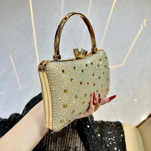 Detail of luxury gold evening clutch bag with sparkling rhinestones and crystal clasp