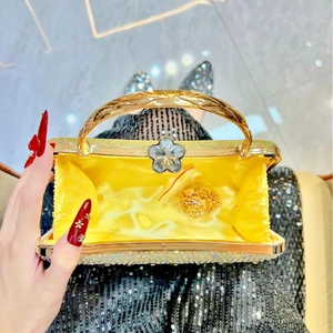 Detailed interior view of a gold evening clutch bag with satin lining and crystal buckle