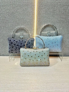 Close-up of sparkling rhinestone evening bags with gemstone clasps in three colors