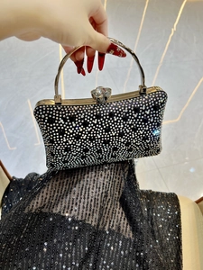Detail of evening clutch featuring shimmering rhinestones and a crystal flower clasp