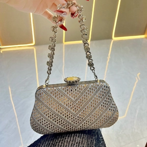 Dettaglio macro di pochette di lusso con strass a V e manico a catena con cristalli