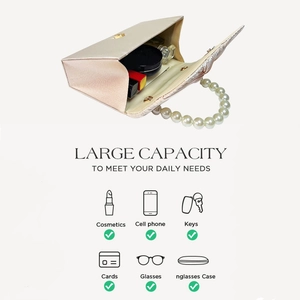 Detail view of champagne satin evening bag with pearl handle and spacious interior