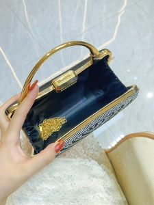 Elegant black evening clutch with sparkling rhinestones and golden metal top handle