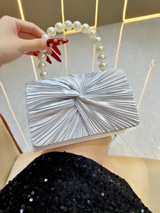 Silver pleated evening clutch bag featuring a large white pearl top handle detail