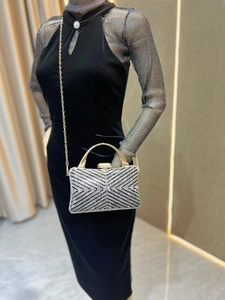 Macro shot of silver rhinestone geometric patterns on luxury evening clutch handbag