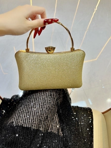 Sparkling gold sequin evening clutch bag with round metal handle and diamond clasp