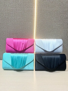 Detail showing four silk pleated evening clutch bags in vibrant satin colors
