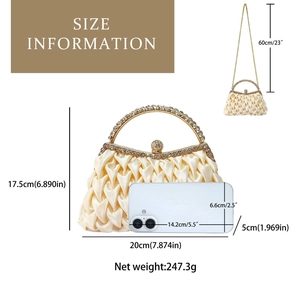Detail of satin evening bag with pleated texture, rhinestone handle and chain strap