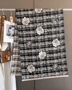 Detail of camellia flower pattern and houndstooth texture on thick cashmere scarf