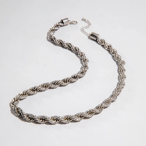 Close-up of silver rope chain necklace with polished metallic finish and lobster clasp